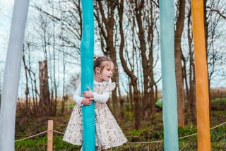 little girl playing on unicorn play area